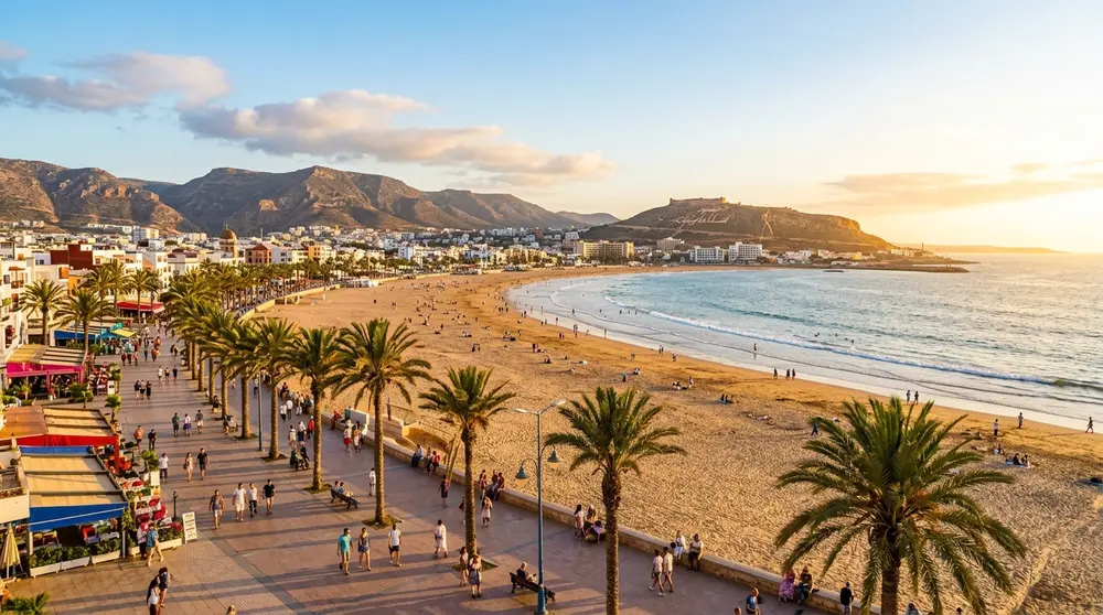 Agadir beach promenade at golden hour with palm trees and Atlantic ocean view