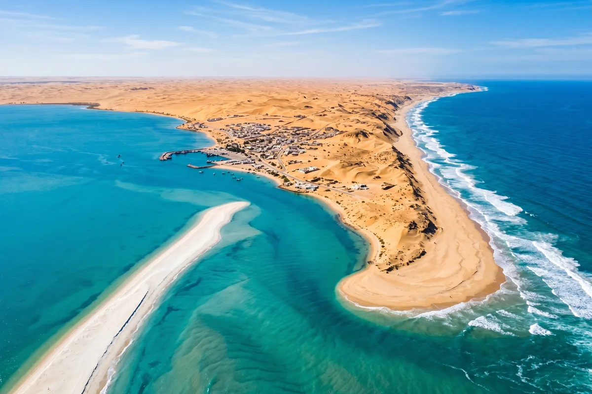 Aerial view of Dakhla lagoon with kitesurfers, the White Dune, and Atlantic Ocean meeting the Sahara desert in Morocco
